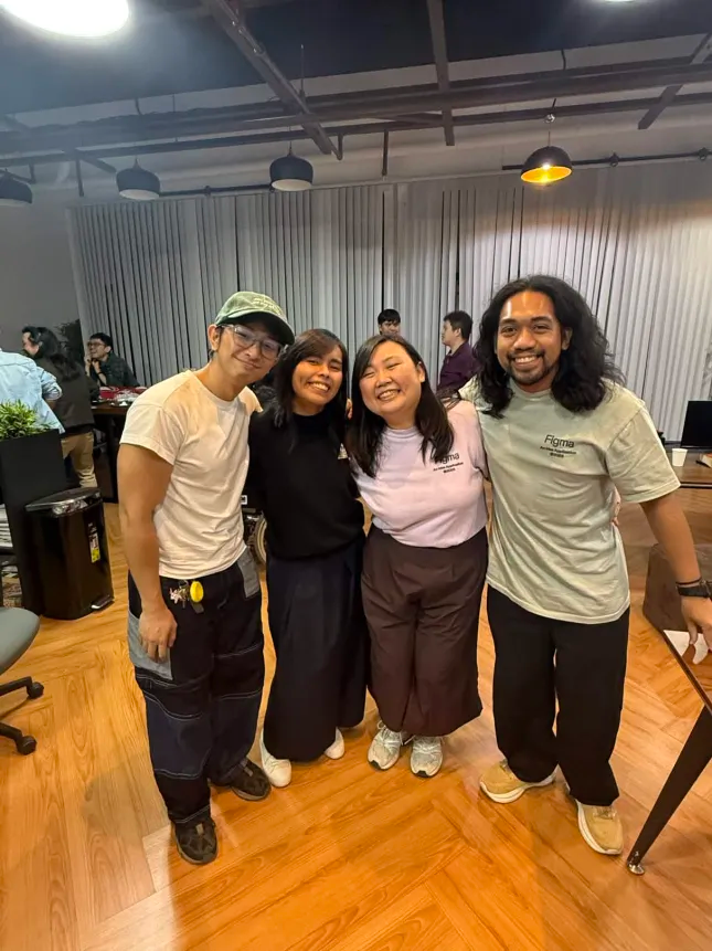 Group of four friends smiling during the Friends of Figma Slides Party