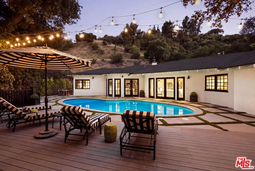Pool deck with string lights at dusk, 16822 Escalon Dr
