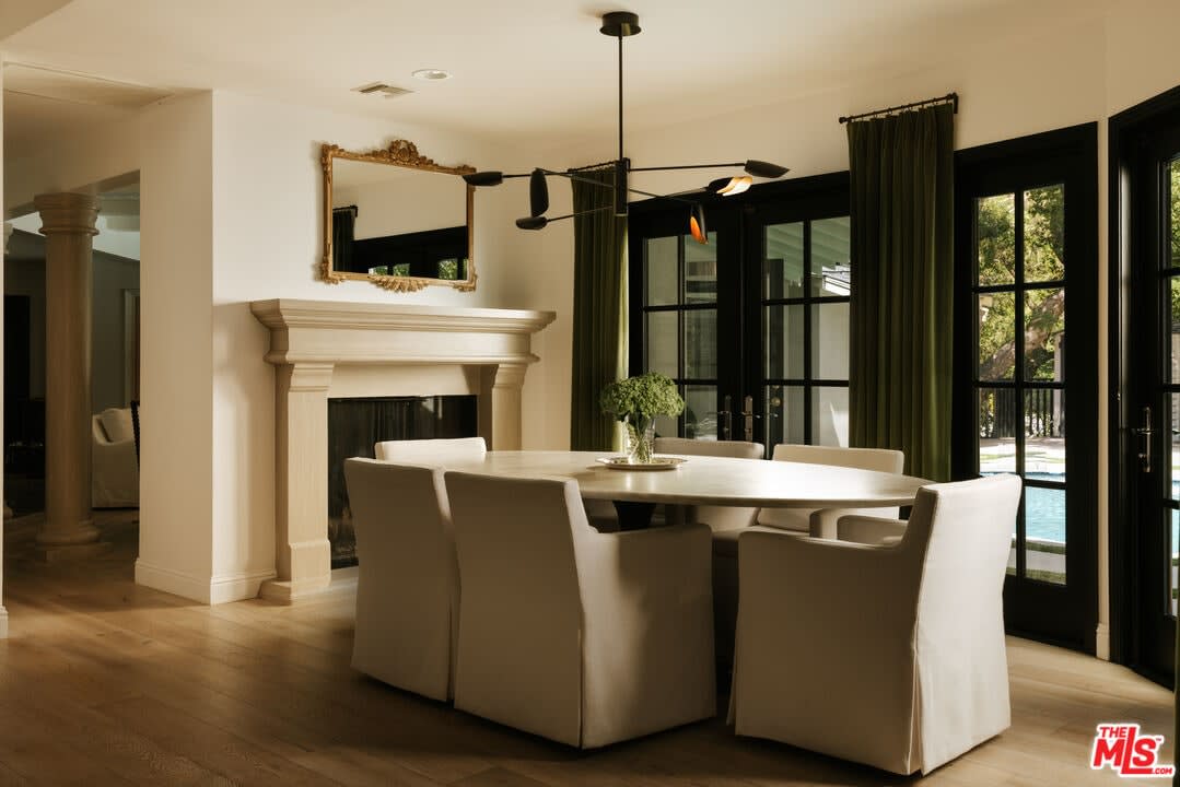 Dining room with stone fireplace and French doors, 16822 Escalon Dr