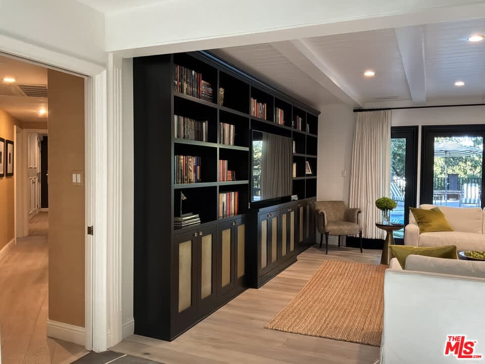 Living room with black built-in shelving, 16822 Escalon Dr