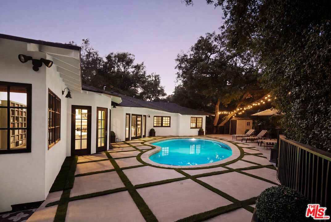 Twilight pool with turf-lined patio, 16822 Escalon Dr