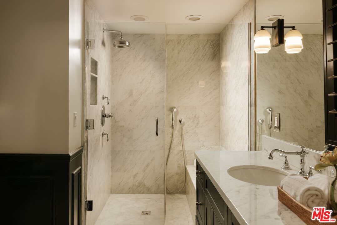 Marble walk-in shower with glass enclosure, 16822 Escalon Dr