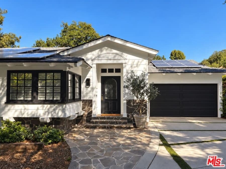 Front exterior with stone walkway and garage, 16822 Escalon Dr