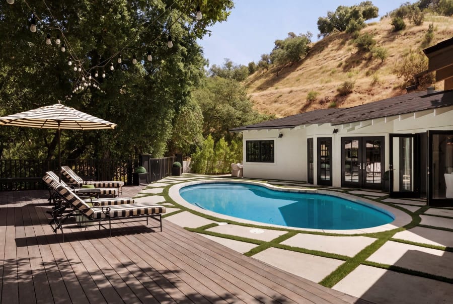 Pool and deck with striped loungers, 16822 Escalon Dr