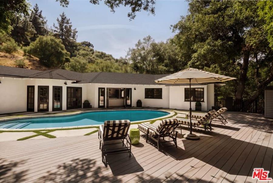 Pool and deck with striped loungers, 16822 Escalon Dr