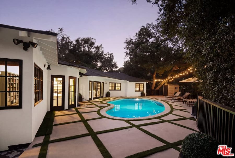 Twilight pool with turf-lined patio, 16822 Escalon Dr
