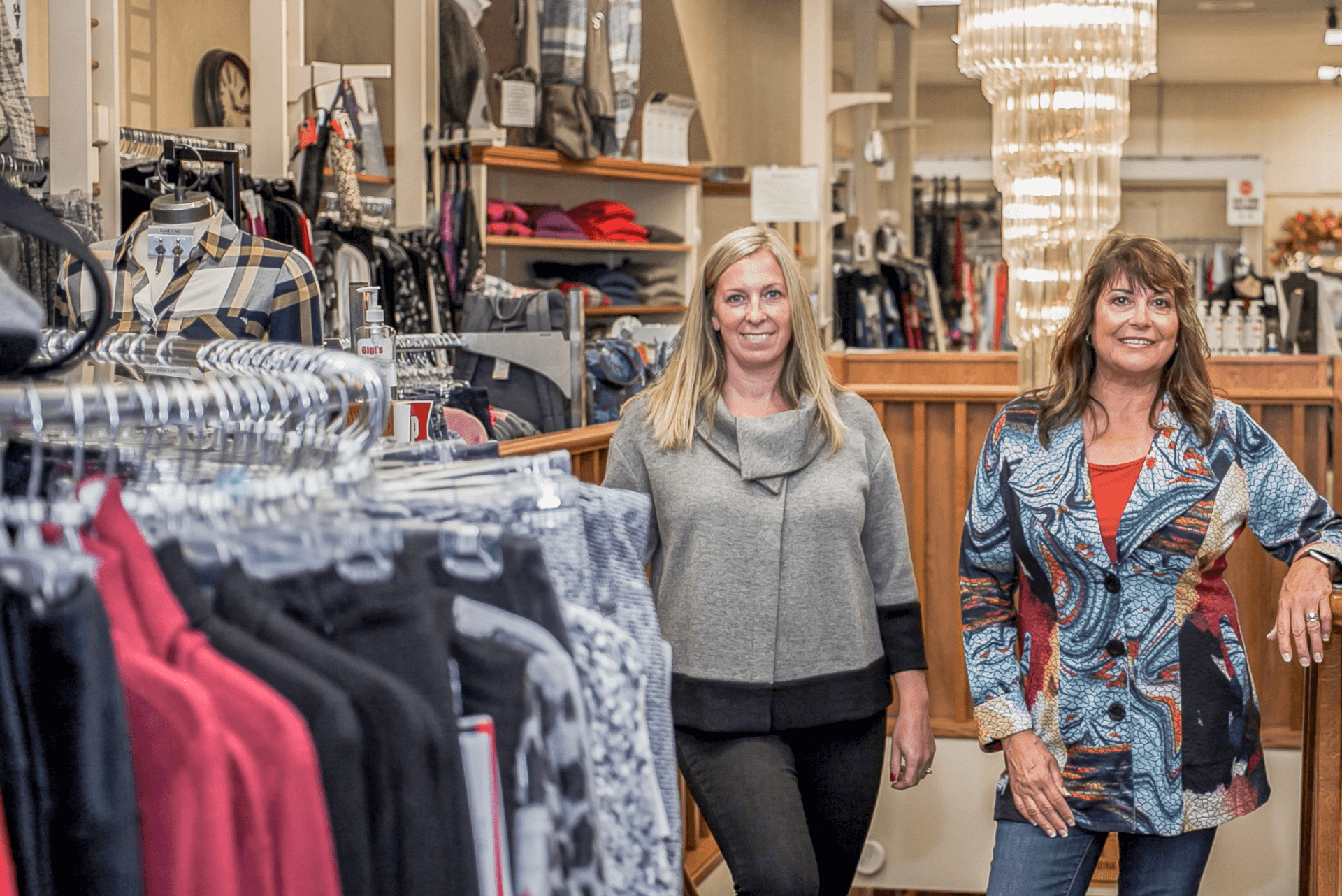 owner and employee standing in clothing store