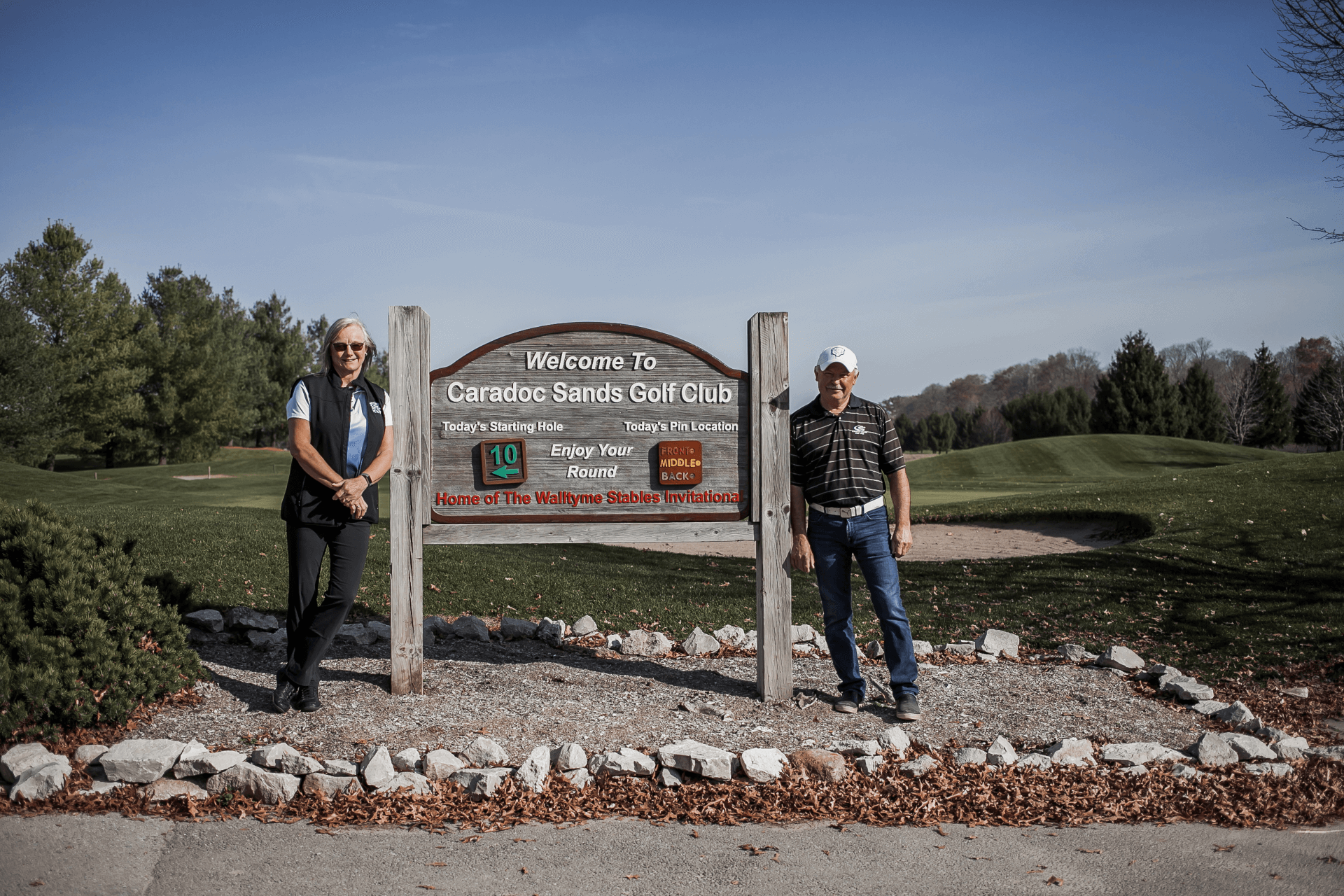 owners standing by sign