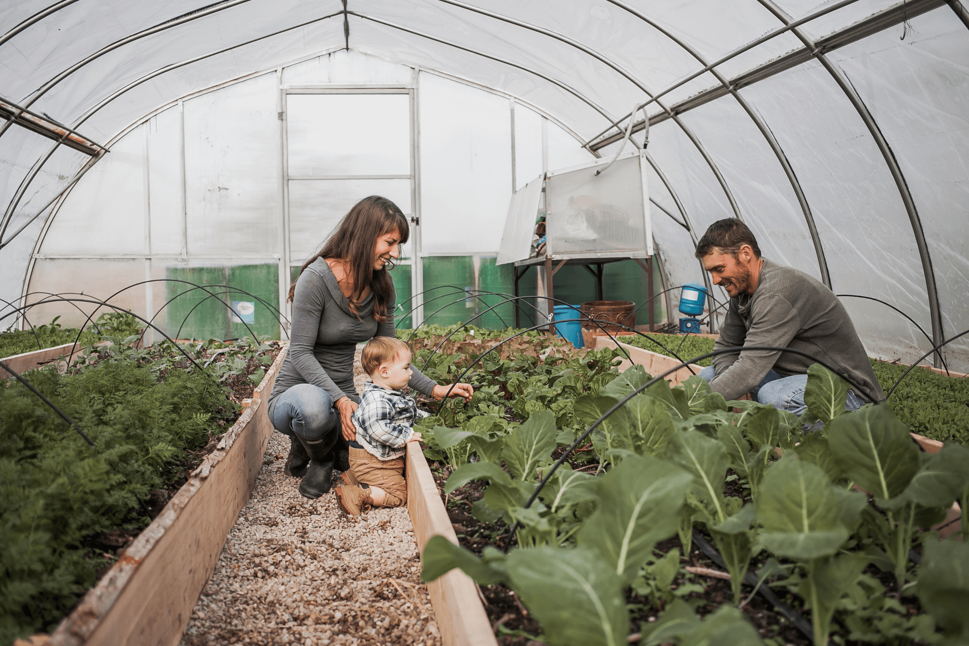 owners with son tending to garden