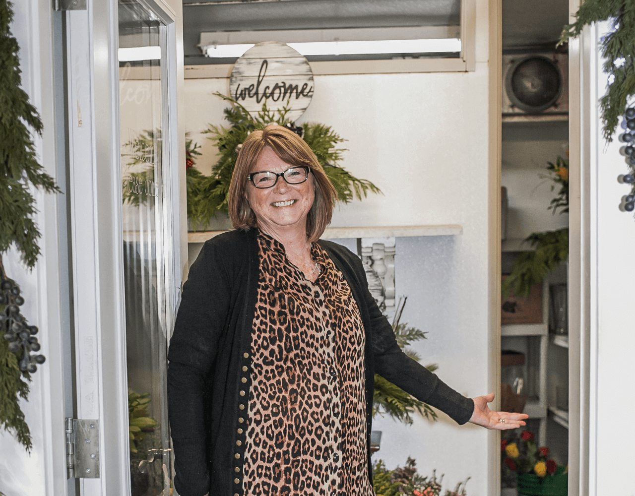 owner in doorway of flower refrigerator