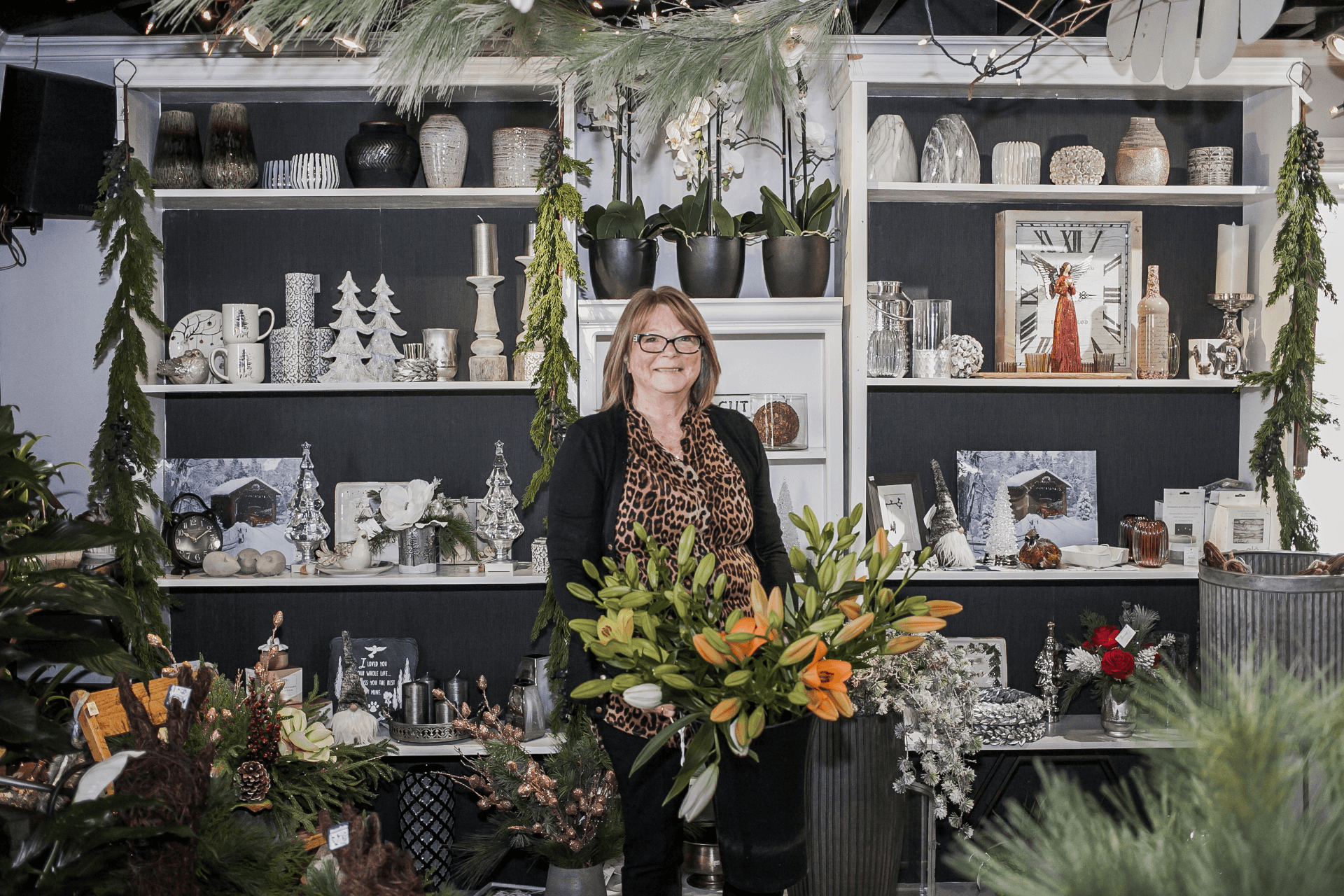 owner standing in front of seasonal decor