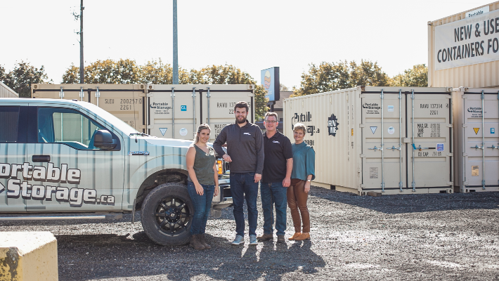 owners standing in front of storage containers