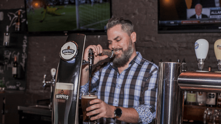 owner pouring a drink