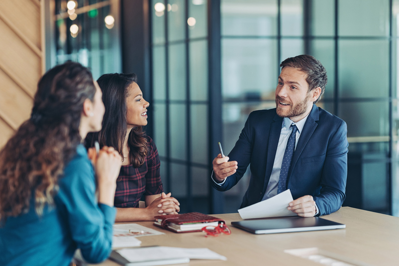 bank employee talking to two female clients