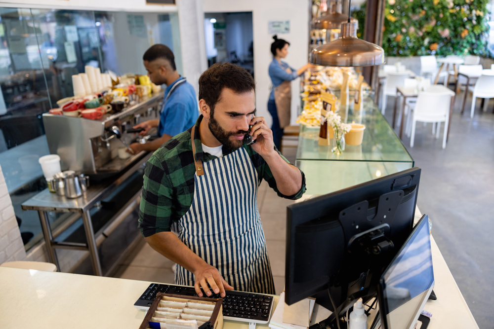 male cashier at a coffee shop