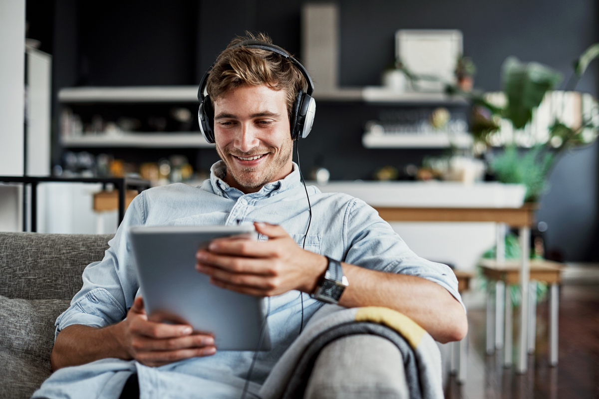Man checking tablet on couch