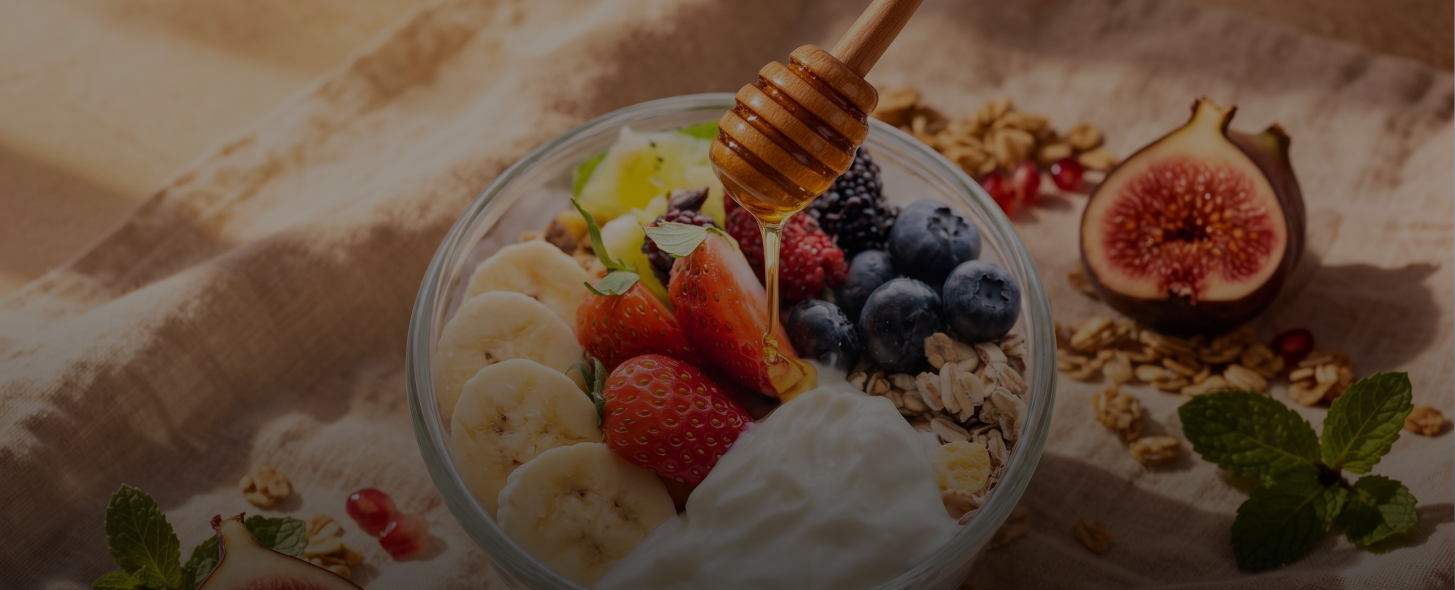 Fresh smoothie bowl held by hand, surrounded by fresh fruit