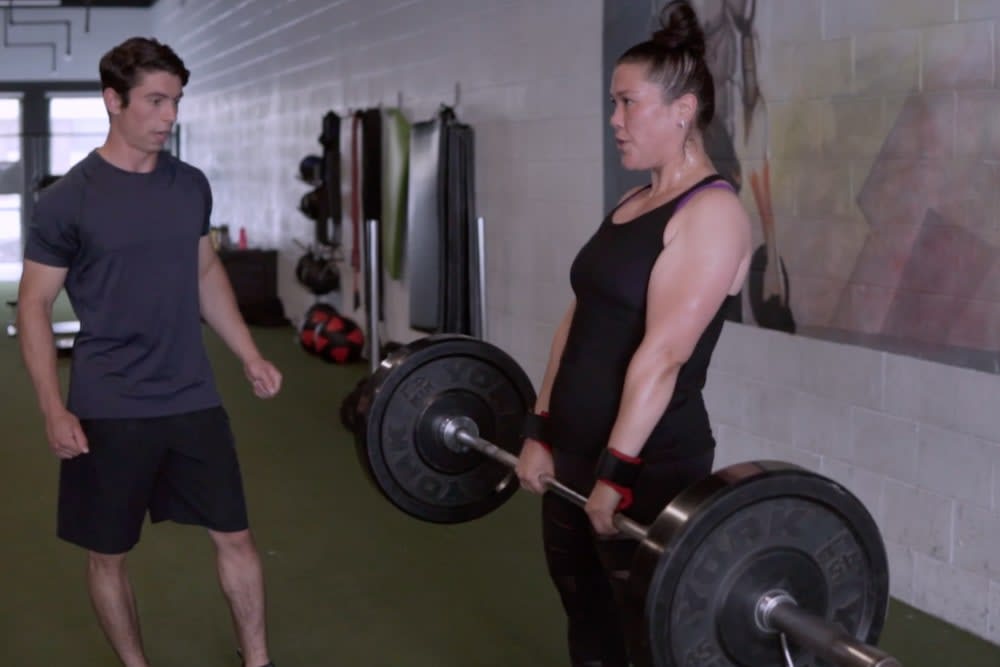 Personal trainer working with client