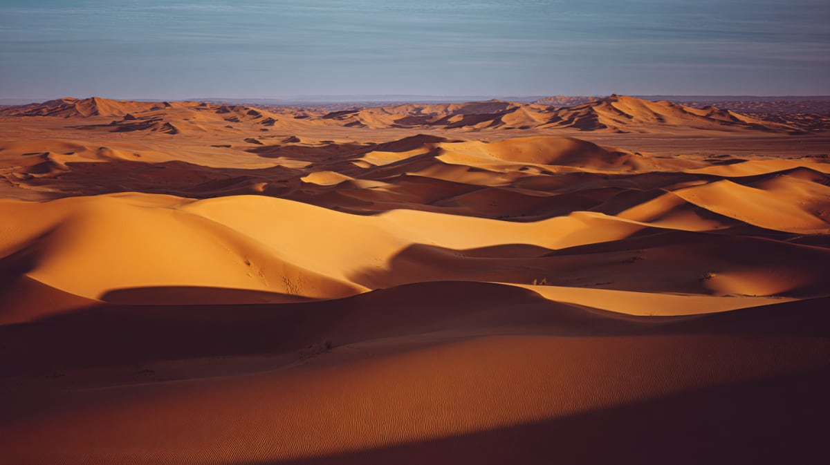 The towering orange dunes of Erg Chebbi at sunrise, Sahara Desert near Merzouga