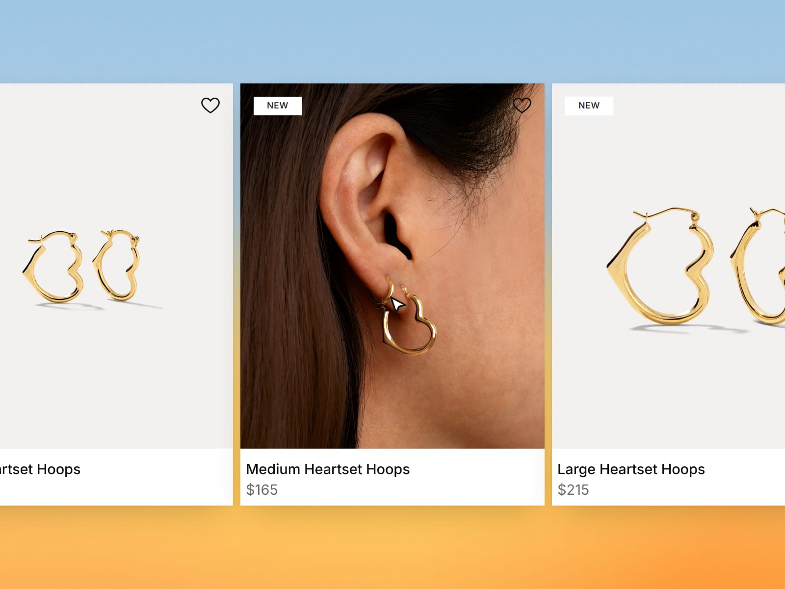 The Small, Medium and Large Heartset Hoops on alliciante.co's New Arrivals page, the medium pair shown worn