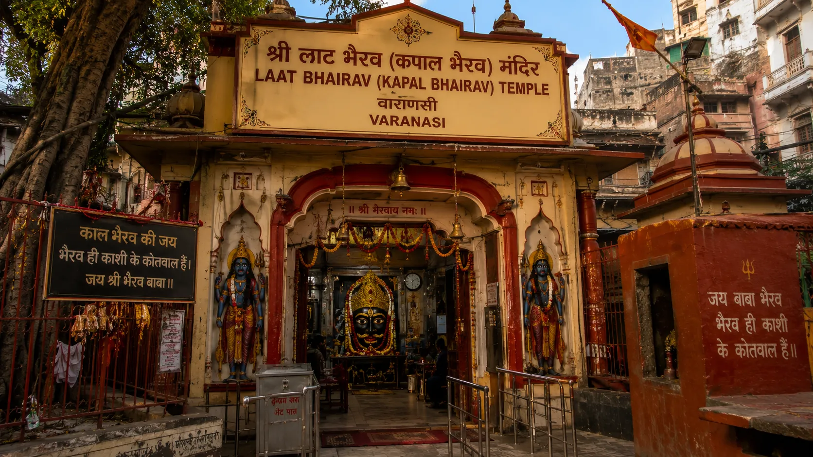 Laat Bhairav Temple Varanasi - The sindoor-covered pillar shrine with Bhairava mask under the open shed