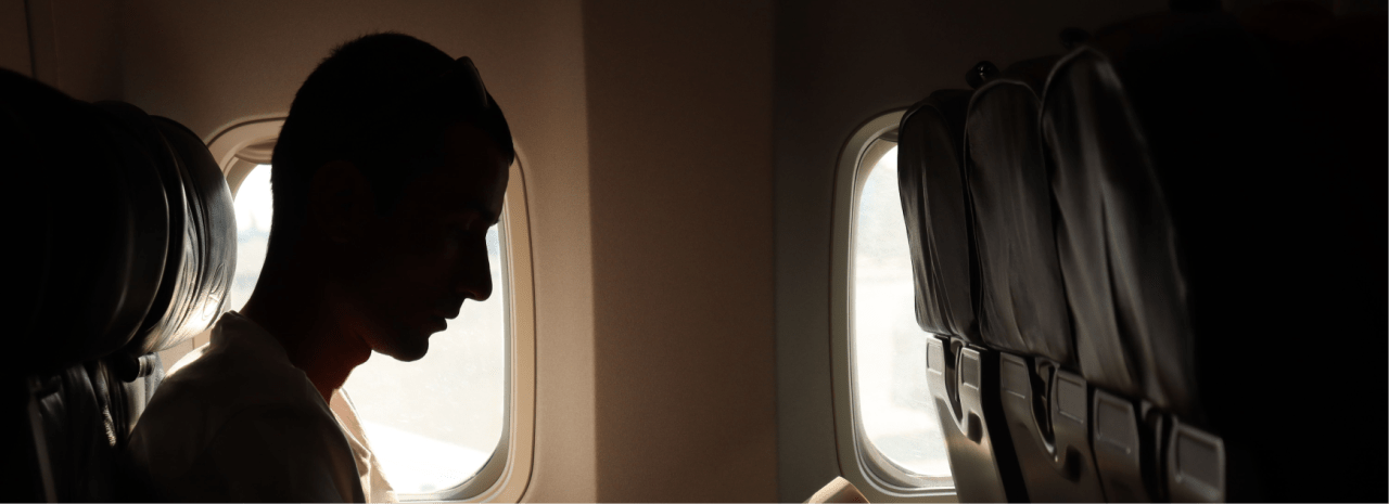 Traveler silhouette by an airplane window
