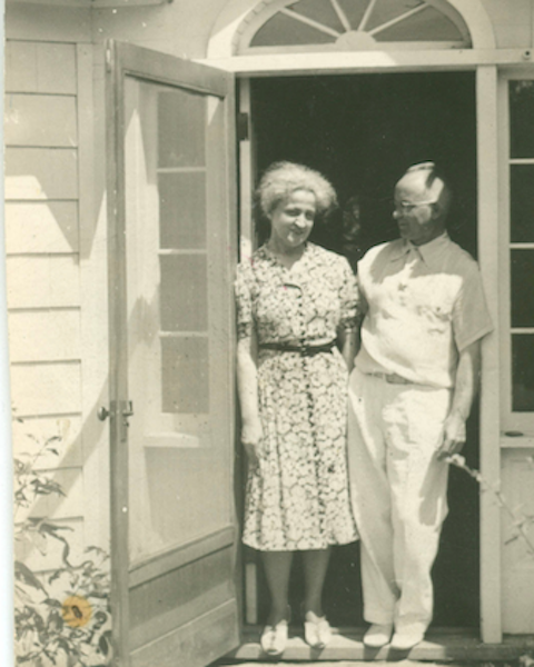 Historic family members standing near a doorway