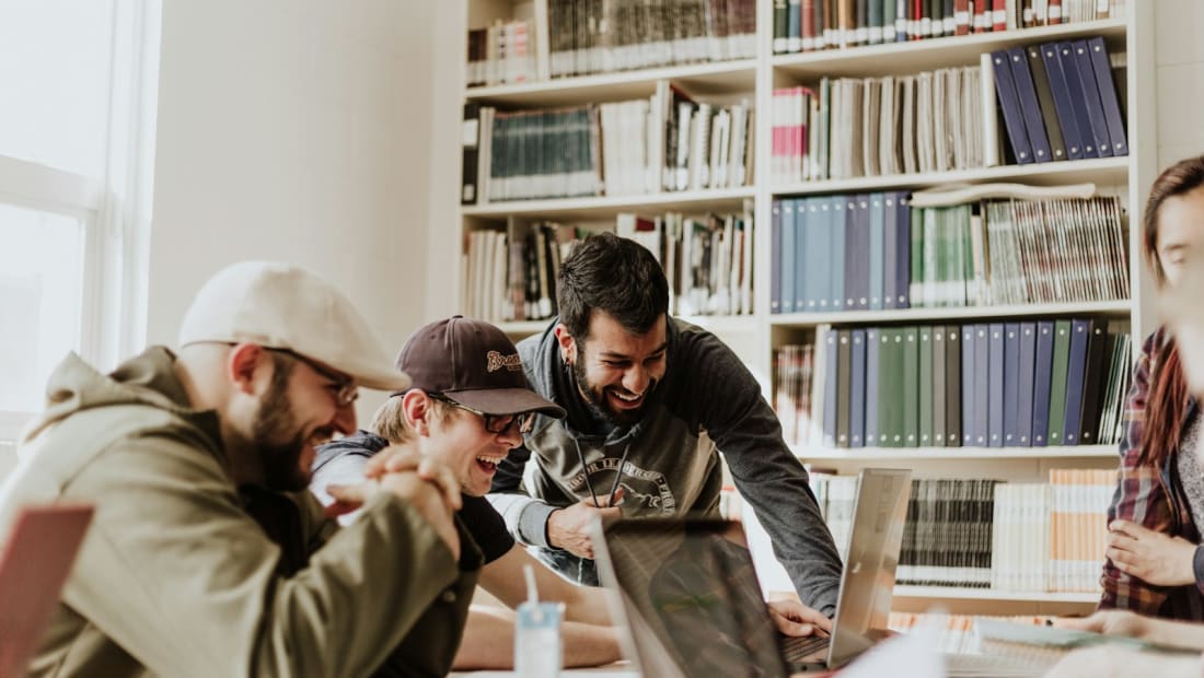 International students studying together with laptops in a library