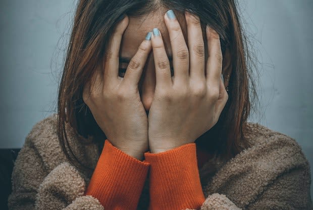 a woman covering her face