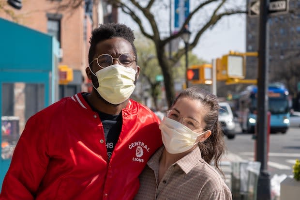 two people wearing masks embracing