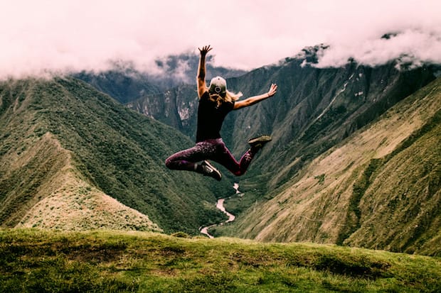 a person leaping in the air, enjoying the great outdoors