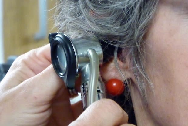 a doctor checking a person’s ear