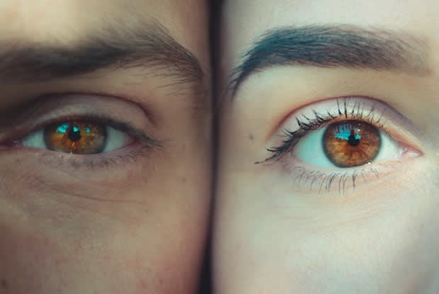 two people pressing their faces together, their eyes next to each other