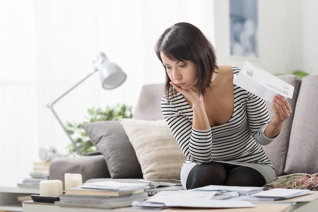 a woman stressing over expensive receipts