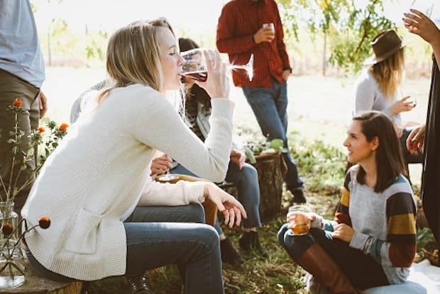 A woman drinking from a wine glass