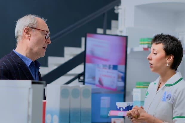 a patient speaking to their prescribing physician at a local pharmacy