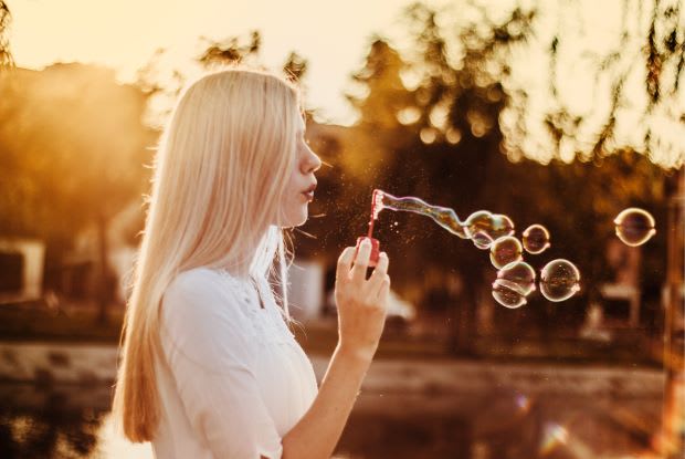 a woman blowing bubbles