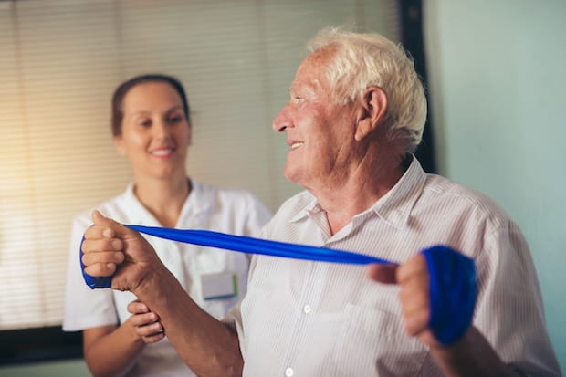 an older man using a resistance band to exercise