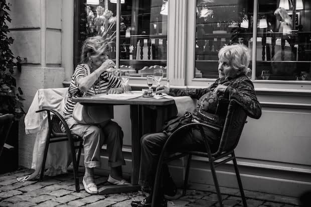 two older women sitting at a table together