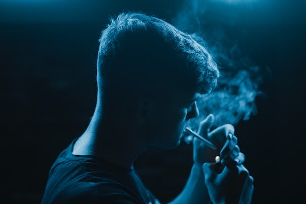 a man smoking a cigarette