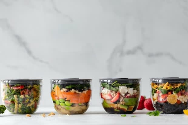 prepared food containers filled with salad