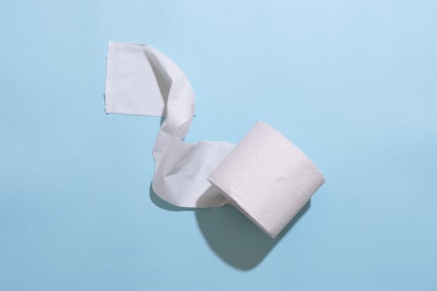 a roll of toilet paper on a baby-blue background