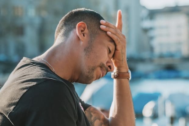 A man holding his head with headache