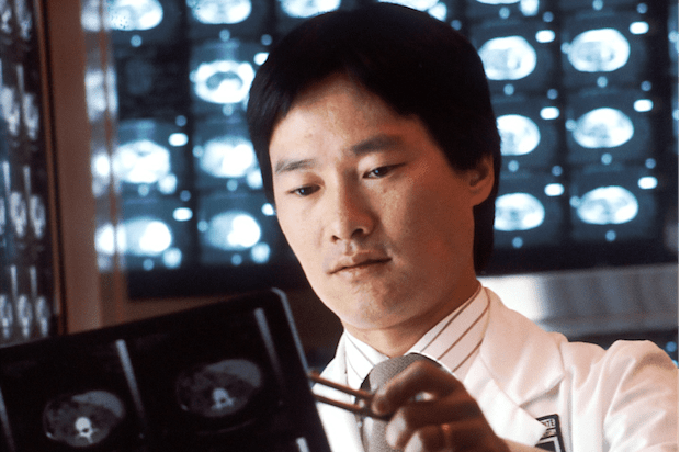 a doctor examining brain scans