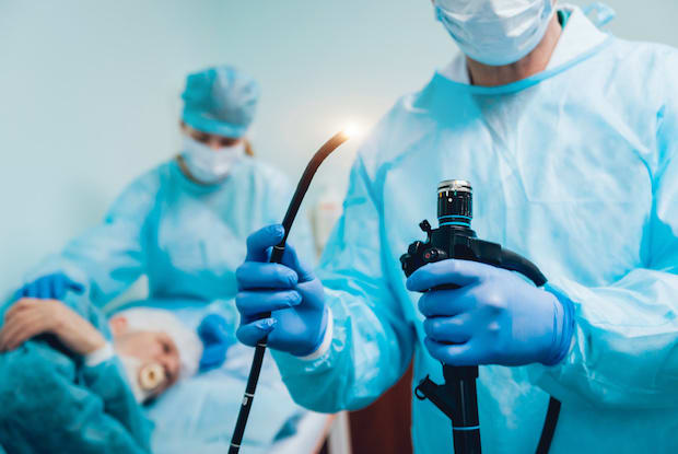 a doctor holding an endoscopy scope