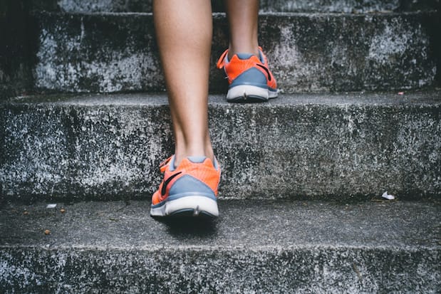 a close-up of a person exercising on stairs