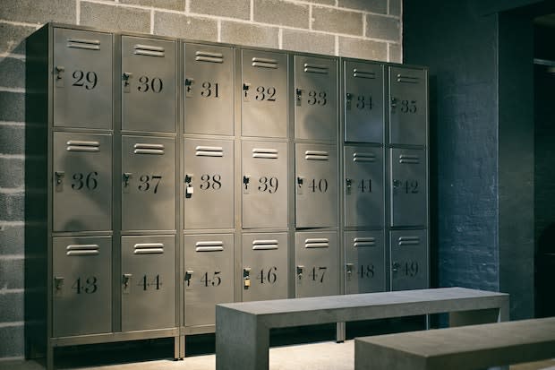 a locker room with metal numbered lockers