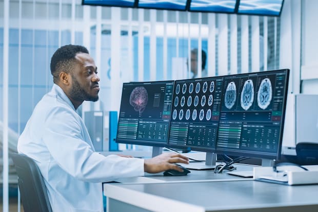 a doctor looking at images of a brain