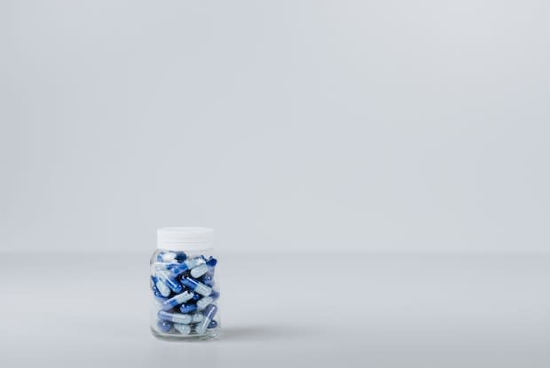 a bottle with blue pills inside