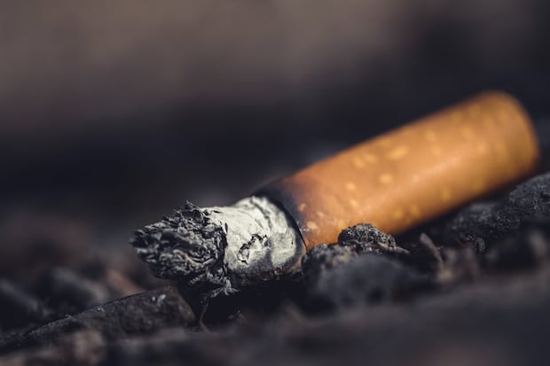 a close-up of a cigarette on the ground